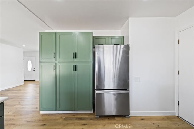 43415 Illinois Ave, Palm Desert, CA 92211 - kitchen with green cabinets, freestanding refrigerator, light wood finished floors, baseboards, and recessed lighting