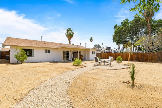 43415 Illinois Ave, Palm Desert, CA 92211 - back of house featuring stucco siding, a patio area, and central AC