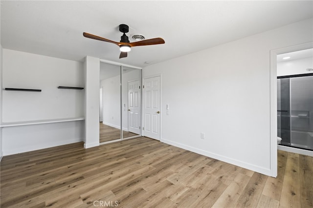 43415 Illinois Ave, Palm Desert, CA 92211 - unfurnished bedroom featuring wood finished floors, ensuite bathroom, baseboards, and ceiling fan