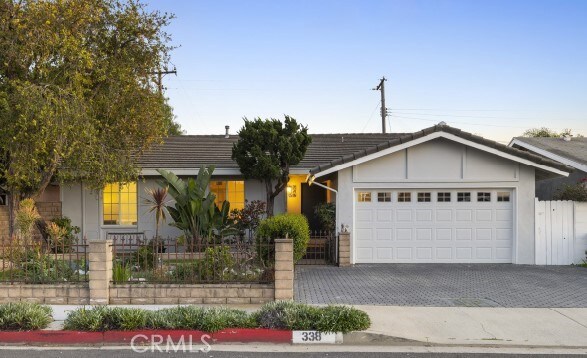 338 E Desford, Carson, CA 90745 - single story home featuring fence, a tile roof, stucco siding, decorative driveway, and a garage
