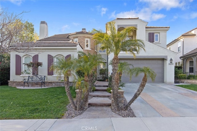 mediterranean / spanish-style home with a garage, a front yard, stucco siding, a chimney, and driveway