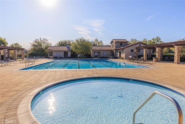 pool with a pergola and a patio area
