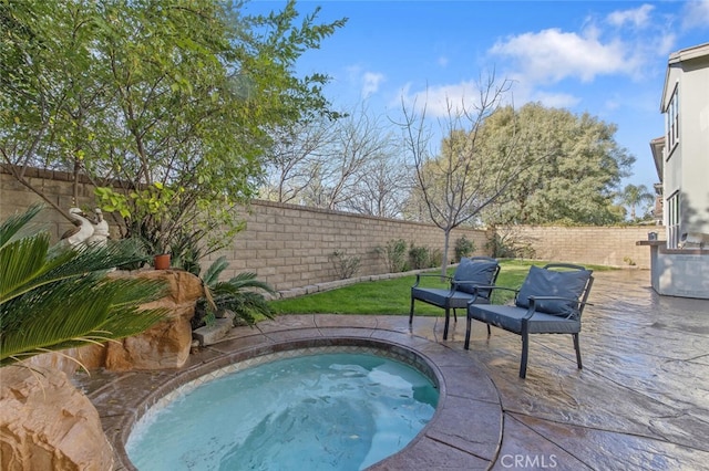 view of swimming pool with a fenced backyard and a jacuzzi