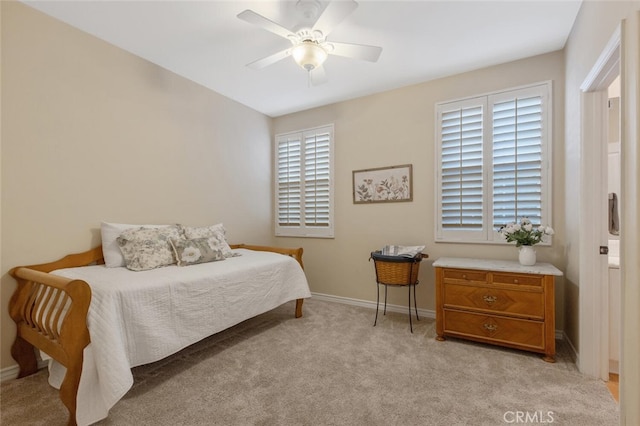 bedroom with light colored carpet, baseboards, and multiple windows