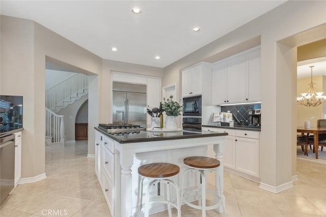 kitchen with light tile patterned flooring, dark countertops, white cabinetry, backsplash, and black appliances