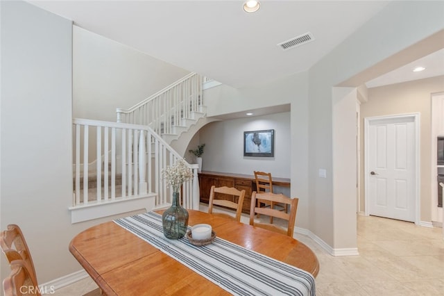 dining area featuring stairs, recessed lighting, baseboards, light tile patterned floors, and visible vents