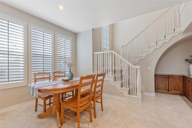 dining space featuring stairway, baseboards, recessed lighting, and light tile patterned flooring