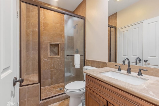 full bathroom with vanity, a stall shower, and toilet