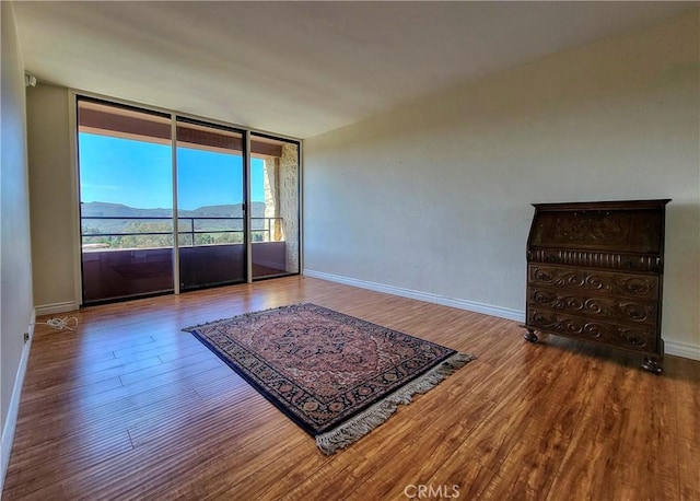 24055 Paseo Del Lago W Unit 1455, Laguna Woods, CA 92637 - empty room featuring baseboards, floor to ceiling windows, and wood finished floors