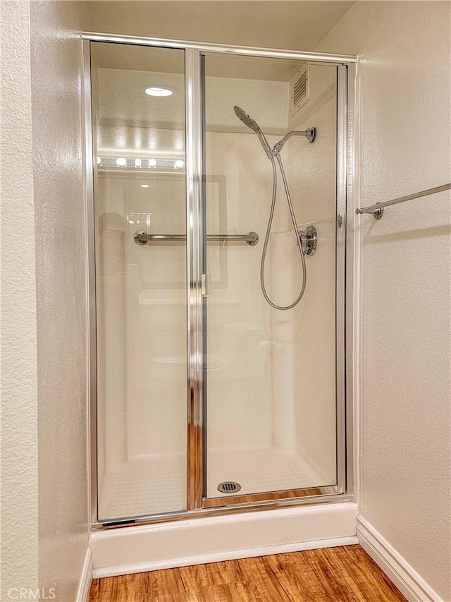 24055 Paseo Del Lago W Unit 1455, Laguna Woods, CA 92637 - bathroom with baseboards, wood finished floors, and a stall shower