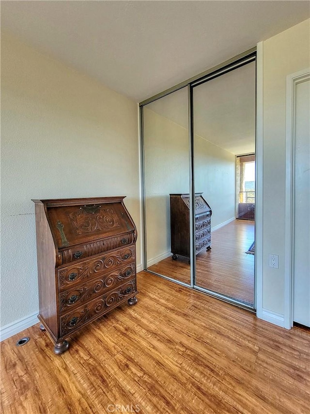 24055 Paseo Del Lago W Unit 1455, Laguna Woods, CA 92637 - bedroom with a closet, baseboards, and wood finished floors