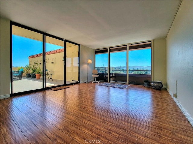 24055 Paseo Del Lago W Unit 1455, Laguna Woods, CA 92637 - spare room with baseboards, floor to ceiling windows, and wood finished floors