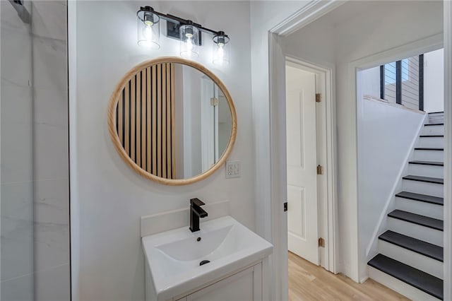 bathroom with wood finished floors and vanity