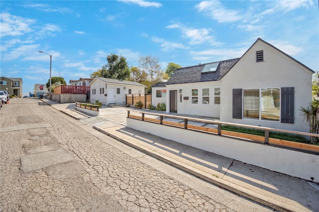 exterior space featuring fence private yard, a residential view, and stucco siding