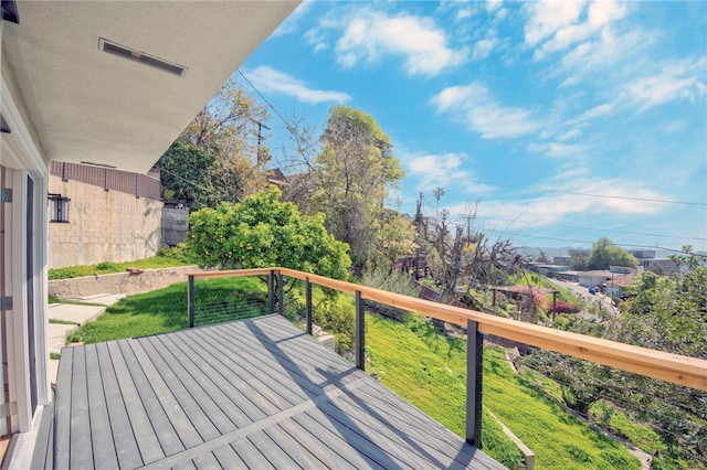 wooden terrace with a lawn