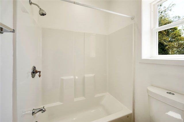 bathroom featuring toilet and shower / tub combination