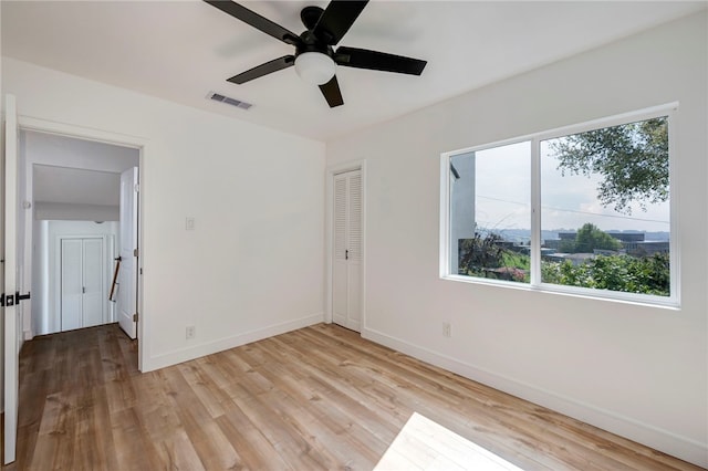 unfurnished bedroom featuring visible vents, baseboards, and multiple windows