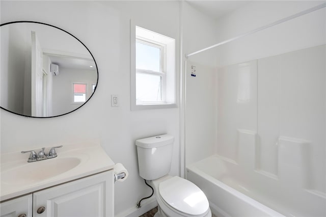 bathroom featuring vanity, tub / shower combination, and toilet