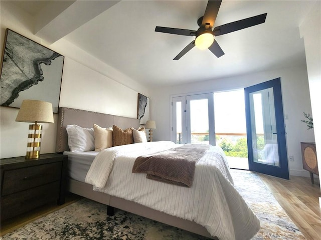 bedroom featuring wood finished floors, access to exterior, baseboards, and ceiling fan