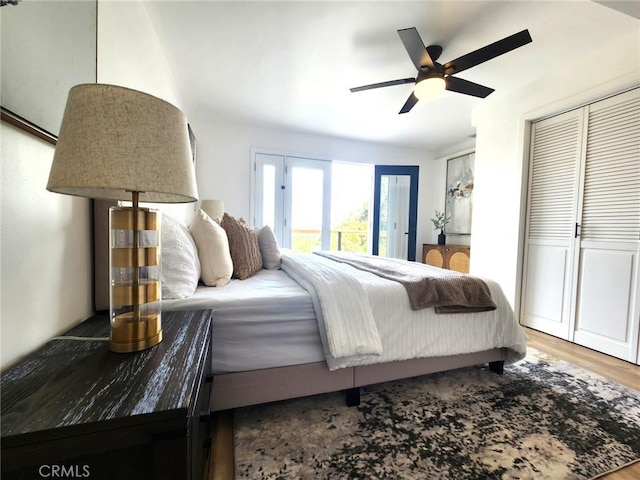 bedroom featuring wood finished floors, access to outside, and ceiling fan