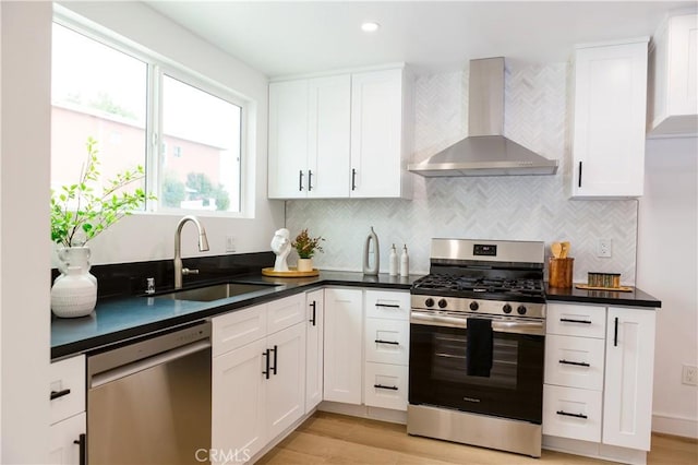 5106 O Sullivan Dr, Los Angeles, CA 90032 - kitchen with wall chimney range hood, appliances with stainless steel finishes, a sink, light wood-style floors, and recessed lighting