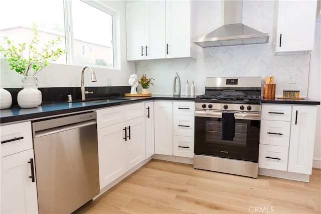 5106 O Sullivan Dr, Los Angeles, CA 90032 - kitchen with stainless steel appliances, wall chimney range hood, a sink, and dark countertops