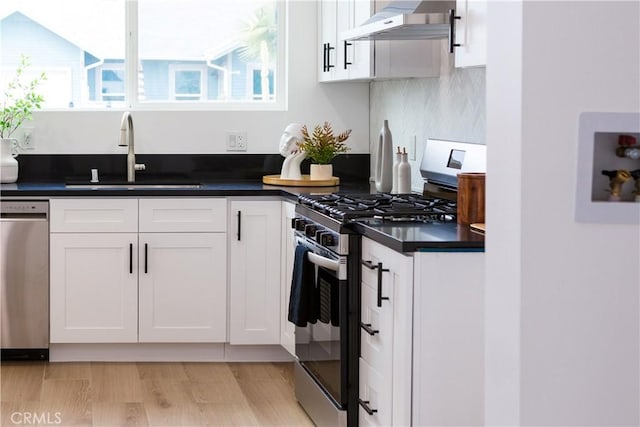 5106 O Sullivan Dr, Los Angeles, CA 90032 - kitchen featuring appliances with stainless steel finishes, under cabinet range hood, a sink, white cabinetry, and dark countertops