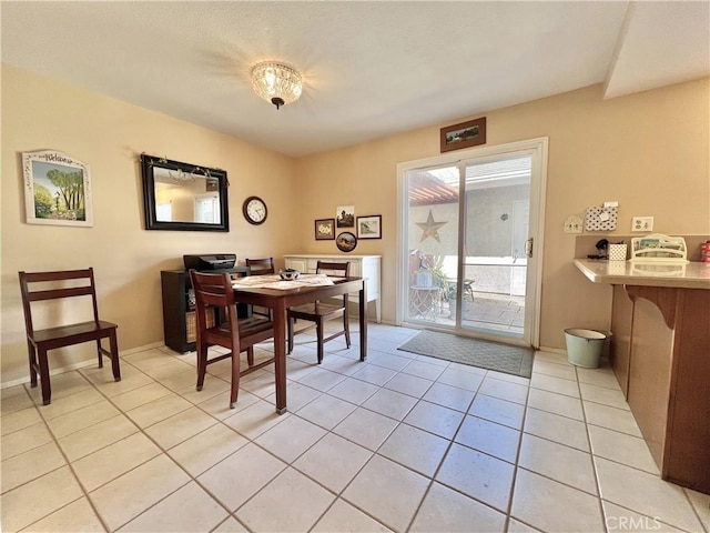 dining area with baseboards and light tile patterned floors