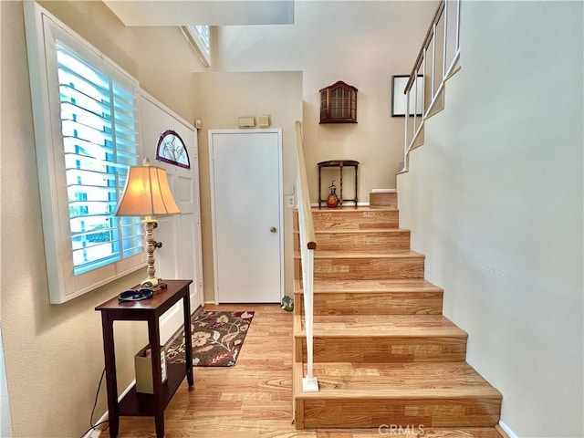 stairs featuring wood finished floors