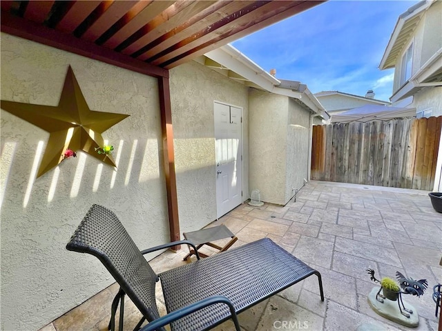 view of patio / terrace featuring fence