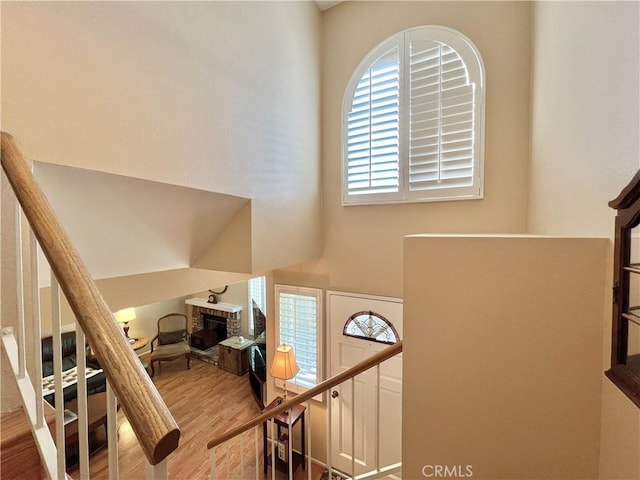 entryway with wood finished floors and a fireplace