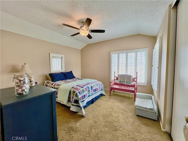 bedroom with carpet floors, multiple windows, a ceiling fan, and lofted ceiling