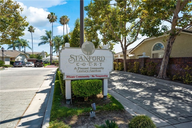 community / neighborhood sign with fence and a residential view