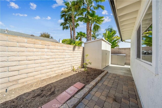22287 Modina, Laguna Hills, CA 92653 - fenced backyard featuring a storage shed, an outbuilding, and a patio area