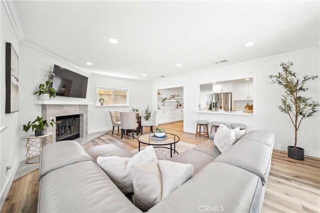 22287 Modina, Laguna Hills, CA 92653 - living room featuring crown molding, a tile fireplace, baseboards, wood finished floors, and recessed lighting