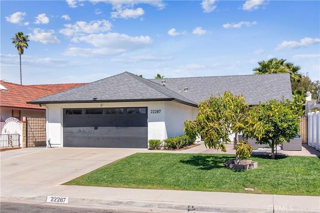 22287 Modina, Laguna Hills, CA 92653 - view of front facade featuring a garage, concrete driveway, stucco siding, and a shingled roof
