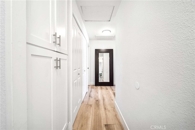 22287 Modina, Laguna Hills, CA 92653 - hall featuring attic access, light wood-style floors, baseboards, and a textured wall