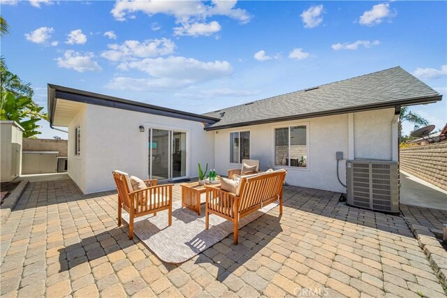 22287 Modina, Laguna Hills, CA 92653 - back of property with cooling unit, stucco siding, a patio area, fence, and outdoor lounge area