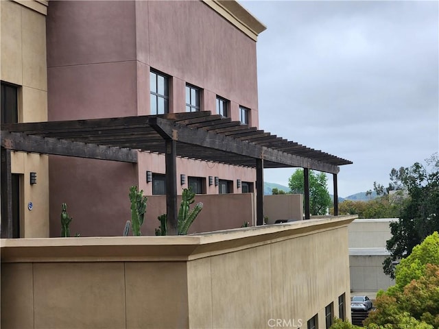 101 W Mission Blvd Unit 306, Pomona, CA 91766 - back of house featuring a pergola and stucco siding