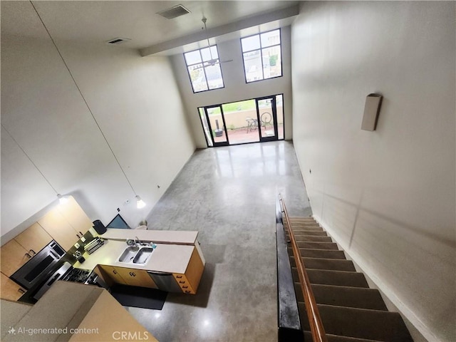 101 W Mission Blvd Unit 306, Pomona, CA 91766 - stairs featuring a high ceiling and concrete floors