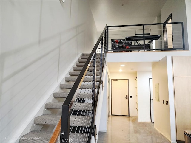 101 W Mission Blvd Unit 306, Pomona, CA 91766 - staircase with a high ceiling