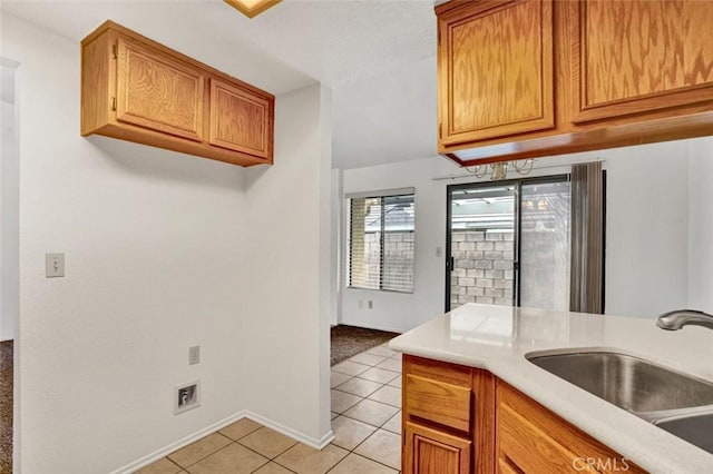 1454 Congress Way, San Jacinto, CA 92583 - kitchen with light countertops, light tile patterned floors, brown cabinetry, and a sink