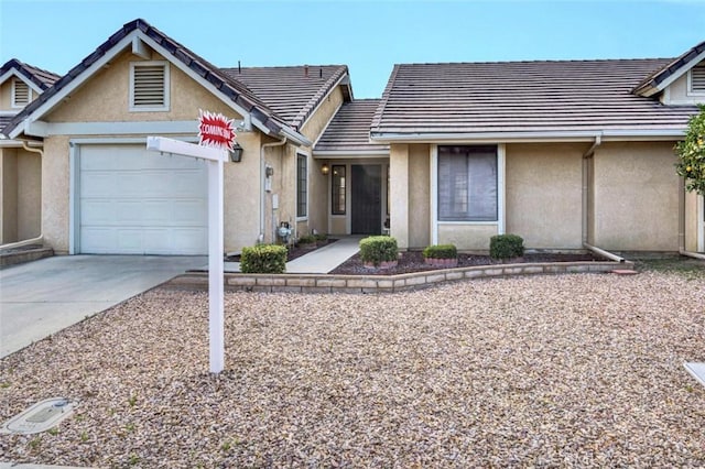1454 Congress Way, San Jacinto, CA 92583 - view of front of home featuring a garage, stucco siding, concrete driveway, and a tiled roof