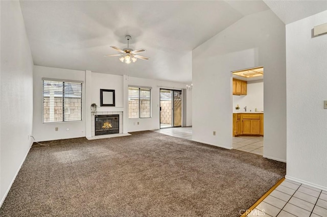1454 Congress Way, San Jacinto, CA 92583 - unfurnished living room with a ceiling fan, a fireplace, vaulted ceiling, baseboards, and light carpet