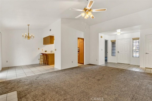 1454 Congress Way, San Jacinto, CA 92583 - unfurnished living room with ceiling fan with notable chandelier, tile patterned flooring, carpet flooring, and lofted ceiling