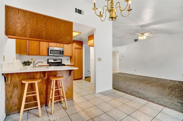 1454 Congress Way, San Jacinto, CA 92583 - kitchen with visible vents, light colored carpet, light countertops, appliances with stainless steel finishes, and light tile patterned floors