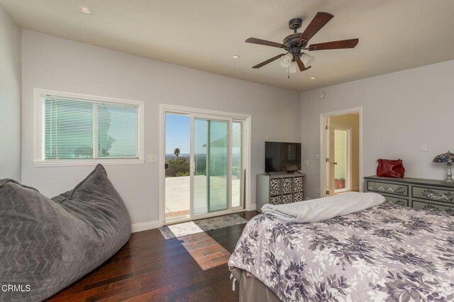 bedroom with dark wood finished floors, access to outside, multiple windows, and recessed lighting