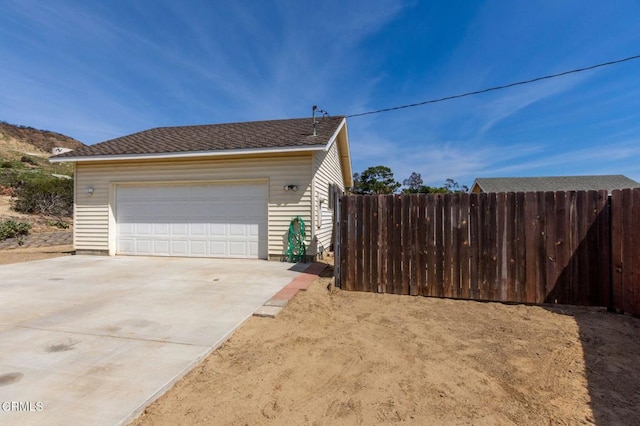 detached garage featuring fence