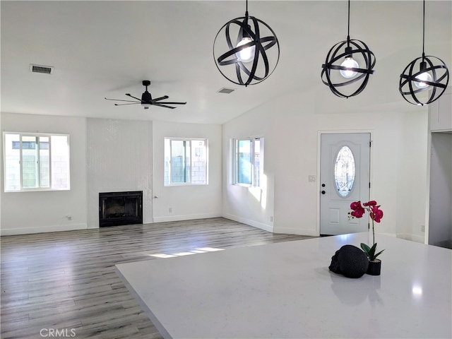 67685 Verona Rd, Cathedral City, CA 92234 - foyer with ceiling fan, a large fireplace, visible vents, wood finished floors, and baseboards