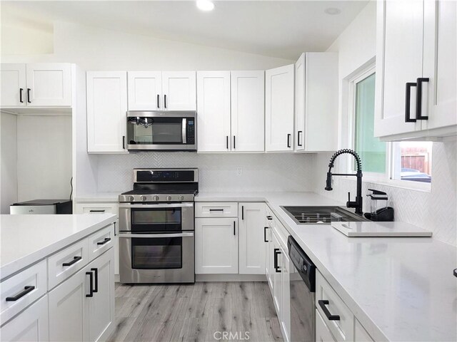 67685 Verona Rd, Cathedral City, CA 92234 - kitchen with a sink, light countertops, appliances with stainless steel finishes, and vaulted ceiling